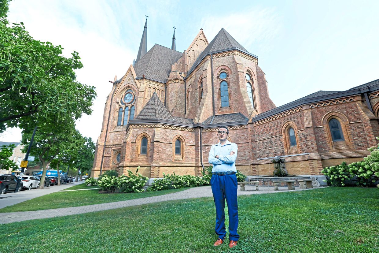 Arriaga posing in front of St Paul’s Catholic Church in the Pilsen neighbourhood of Chicago. — AFP 