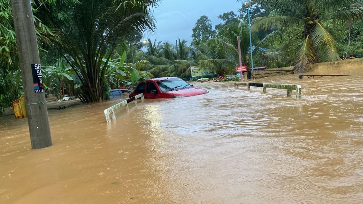 Cars damaged near a campsite in Tanjung Malim after a major kepala air (water surge) incident occurred in the area in the wee hours of Monday.