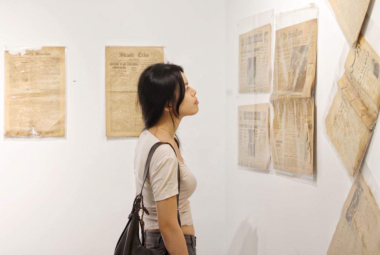 A visitor browses pre-Merdeka newspapers at the 'Seeds Of Resistance: Journey Towards Independence' exhibition at GMBB, Kuala Lumpur. Photo: The Star/Muhamad Shahril Rosli