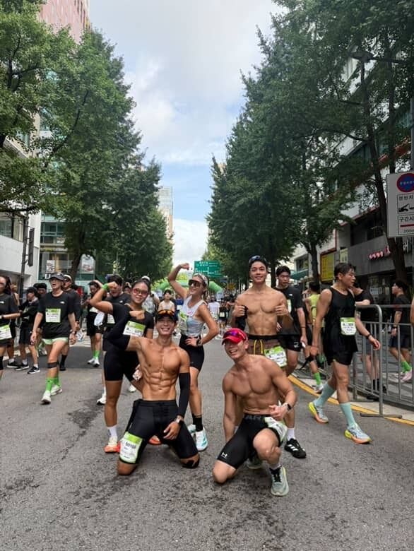 Yun (bottom left) with two male running partners, all shirtless, and two female runners during a run. - Photo courtesy of Yun