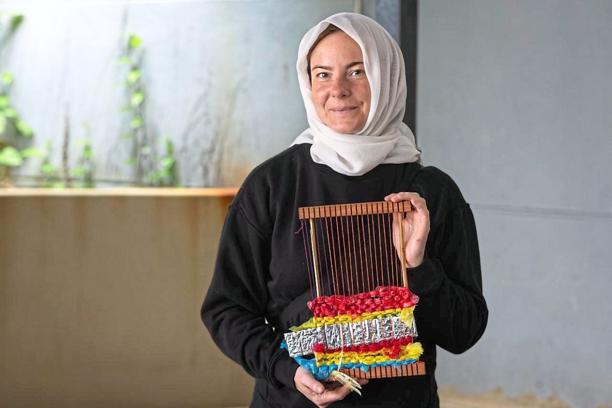 Wagner showing a weaving with plastics work in progress.