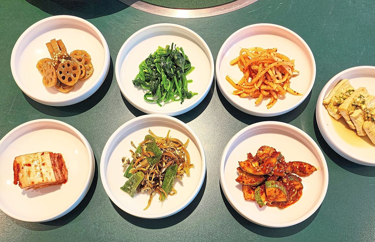 The eatery serves up a range of complimentary banchan that includes lotus root, sauteed spinach and kimchi, to name a few. — ABIRAMI DURAI/The Star