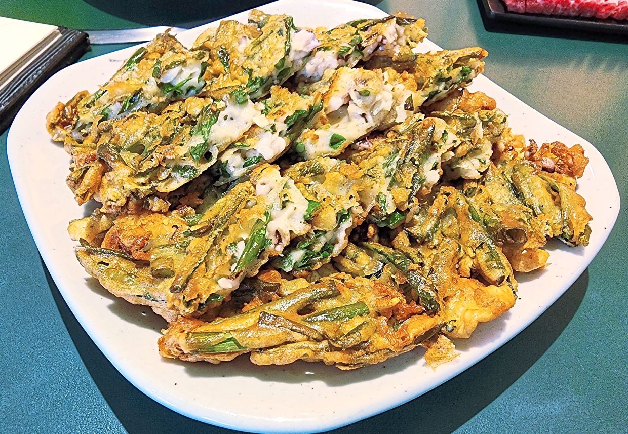 The Korean pancake is delightfully crispy and filled with scallions and seafood. — ABIRAMI DURAI/The Star
