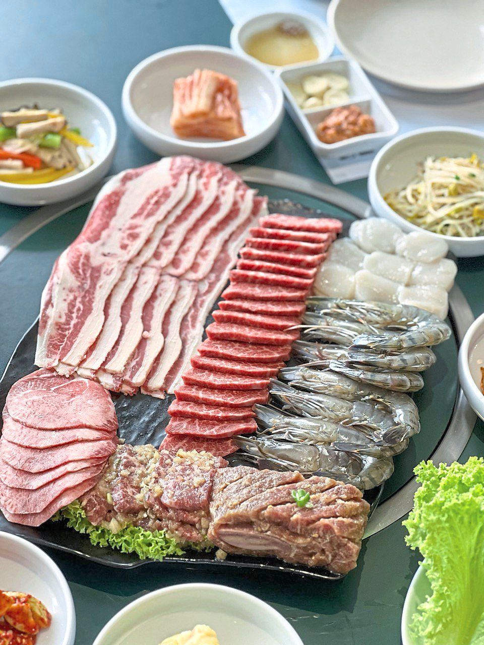 The mix barbecue is a gargantuan platter that offers various cuts of beef as well as prawns and scallops. — Kung Jung