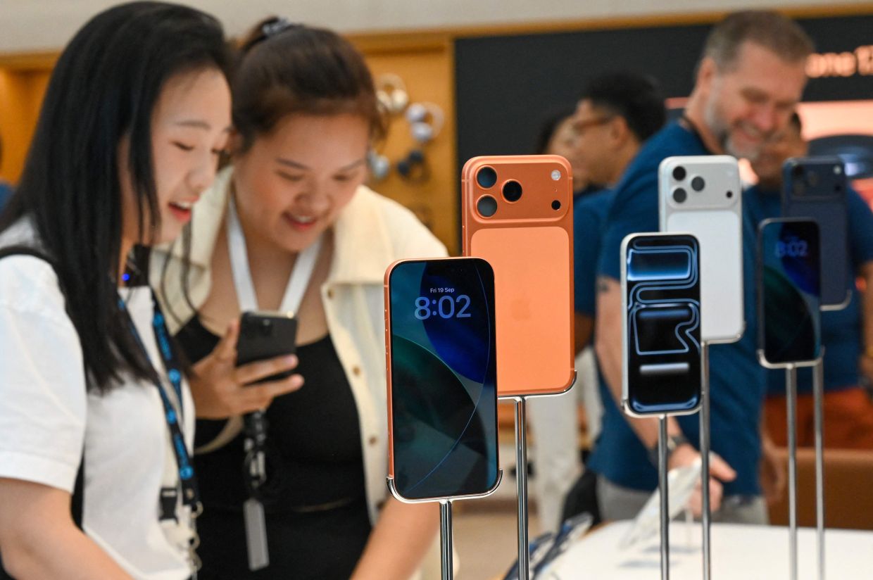 People look at the launch of the new iPhone 17 series in Singapore on Friday, September 19, 2025. -- Photo by Roslan RAHMAN / AFP