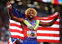 Athletics-Lyles surges late to win fourth successive 200m gold