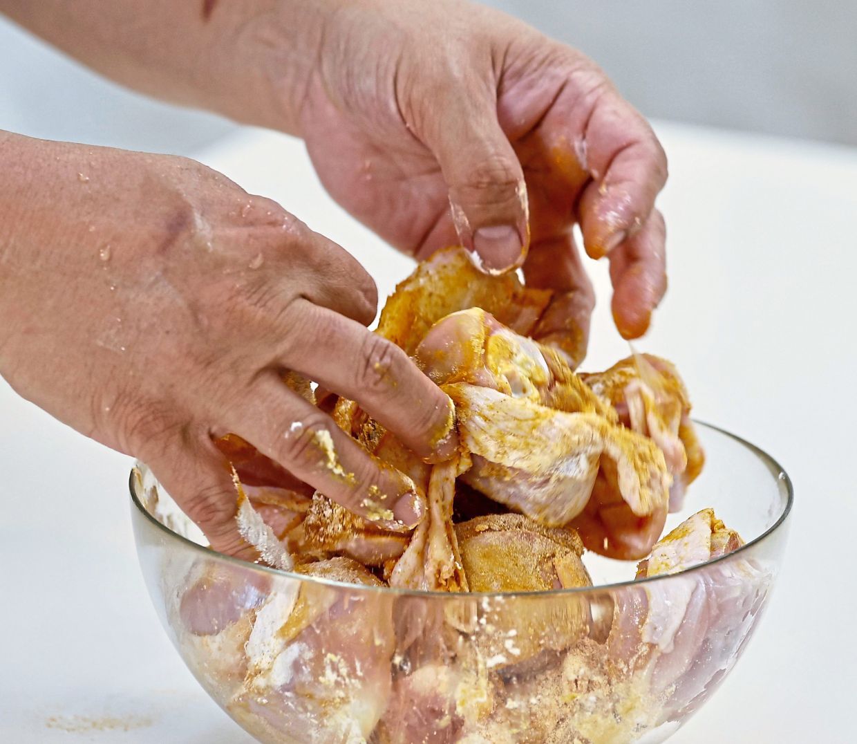 A simple marinade of turmeric powder, cornstarch, salt and pepper (above) is all that is needed, before deep-frying in sesame oil (below).