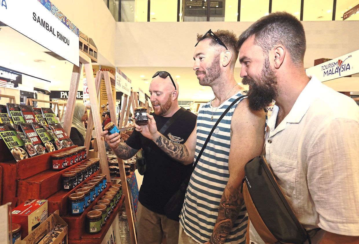 Cultural bridge: Tourists checking out sambal at one of the booths during the Cuti-Cuti Malaysia Carnival.