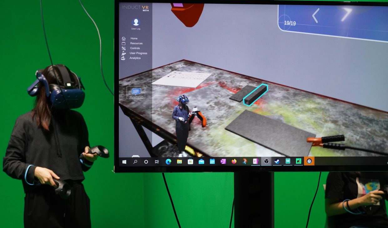 A student uses a VR headset to practice woodworking and welding in virtual reality. — Taylor’s University