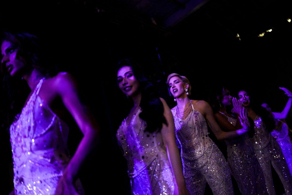 Olivia Lauren of Cuba (centre) reacts as she prepares backstage during the final round of Miss International Queen 2025 transgender beauty pageant in Pattaya city, Thailand. Photo: REUTERS/Athit Perawongmetha