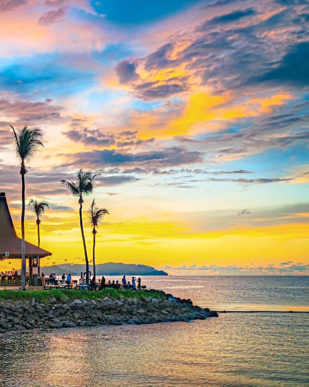 Palm trees, ocean breeze and a sunset that turns the coastline into a painting.