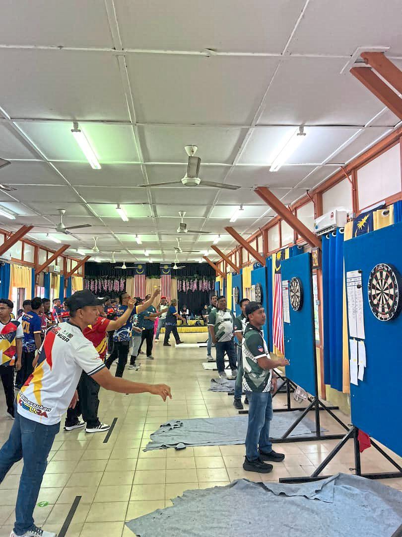 Participants taking part in indoor games such as darts.