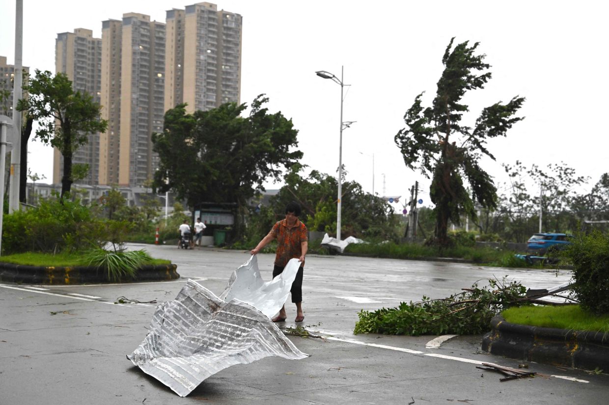 A woman clears debris after the passing of Typhoon Ragasa in Yangjiang, southern Chinas Guangdong province on September 24, 2025. Fierce winds, pounding rain and rough seas battered southern China on September 24 as powerful Typhoon Ragasa made landfall in Guangdong province after killing at least 17 in Taiwan. - Photo: AFP