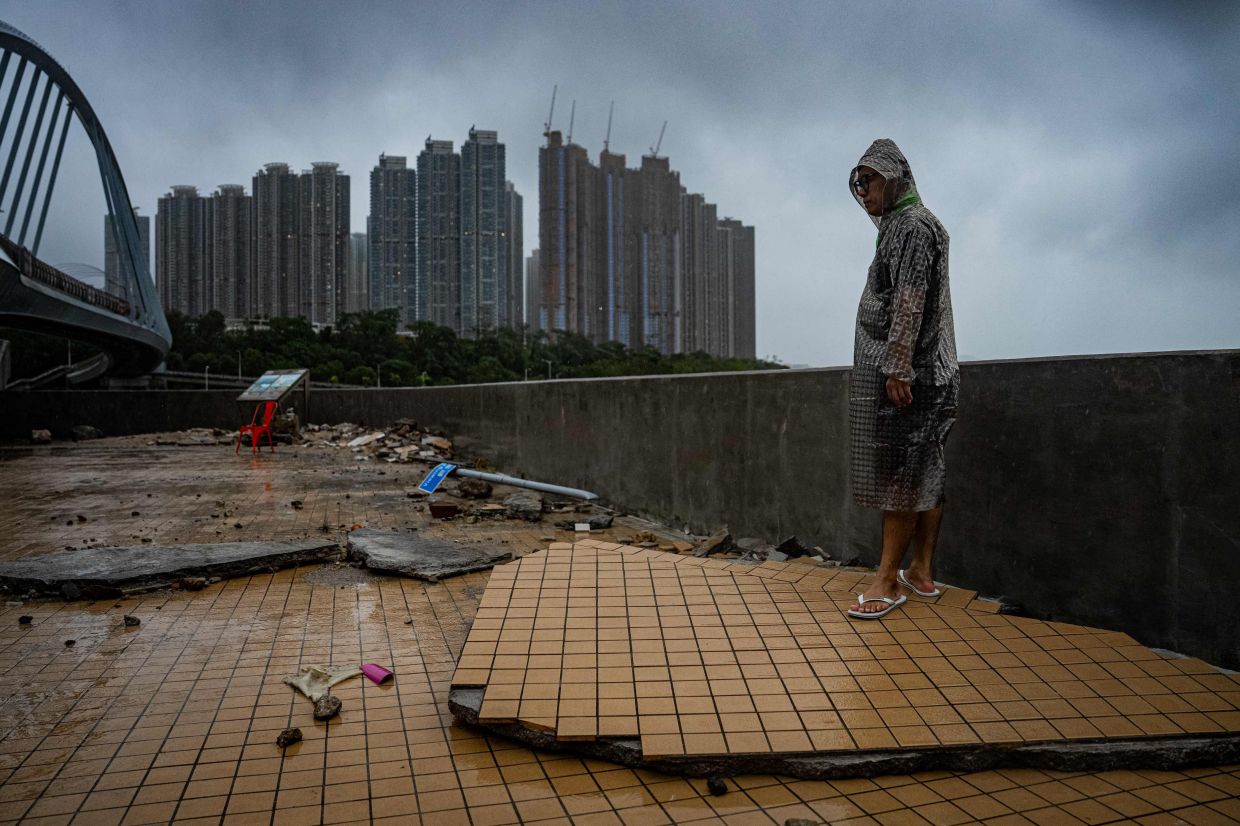 A man stands on a damaged pavement in Tseung Kwan O after Super Typhoon Ragasa hit Hong Kong on September 24, 2025. Fierce winds, pounding rain and high seas battered Hong Kong on September 24 as Super Typhoon Ragasa made landfall in Guangdong Province after killing at least 17 in Taiwan. - Photo:AFP