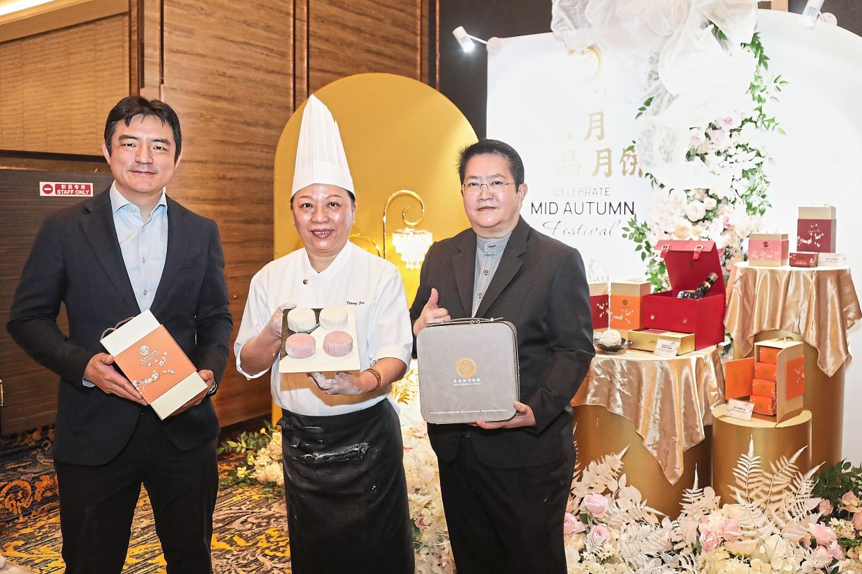 (From left) Wong, Foo and Group business development manager Maggie Chow holding mooncakes during the review.