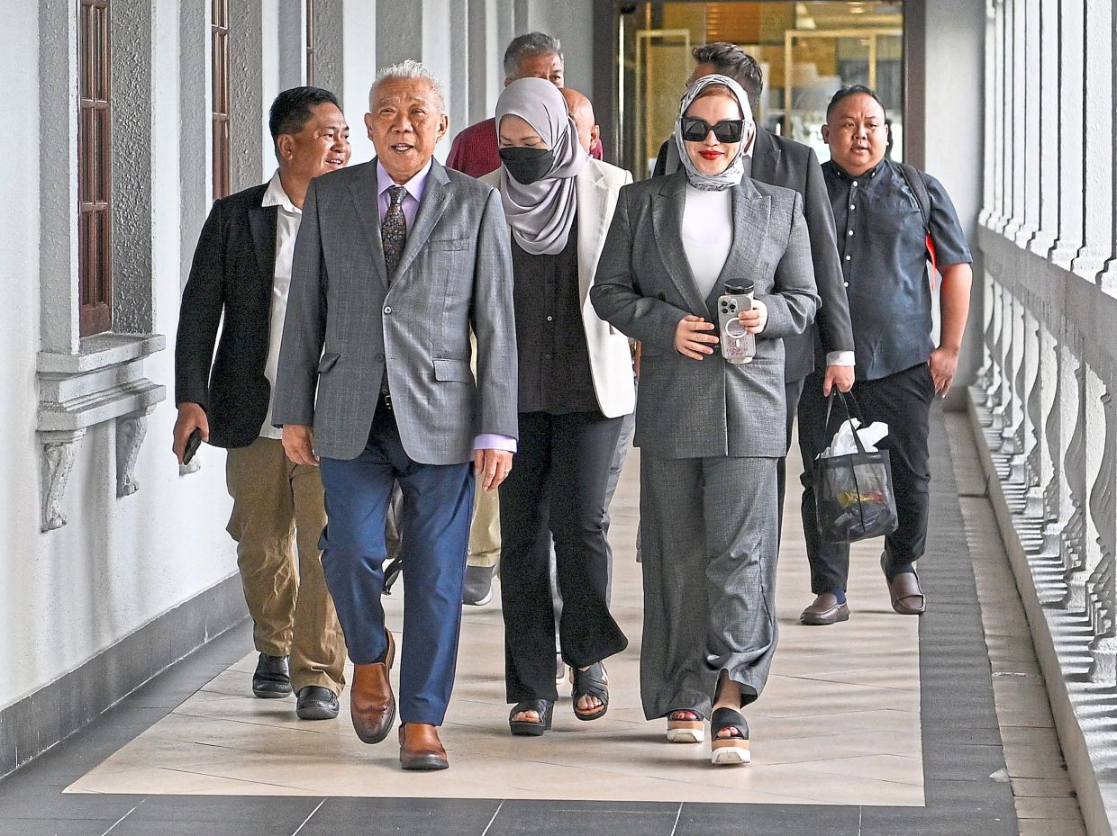 Day in court: Bung Moktar (front left) and Zizie (front right) arriving at the Sessions Court in Kuala Lumpur. — Bernama