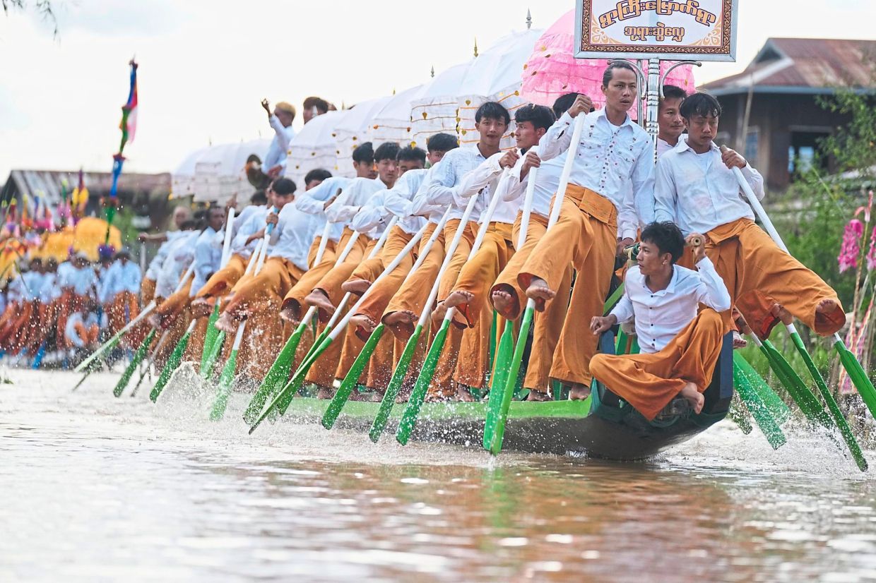 Faith afloat: An Ethnic Intha troupe performing during the Phaung Daw Oo pagoda festival. — AP
