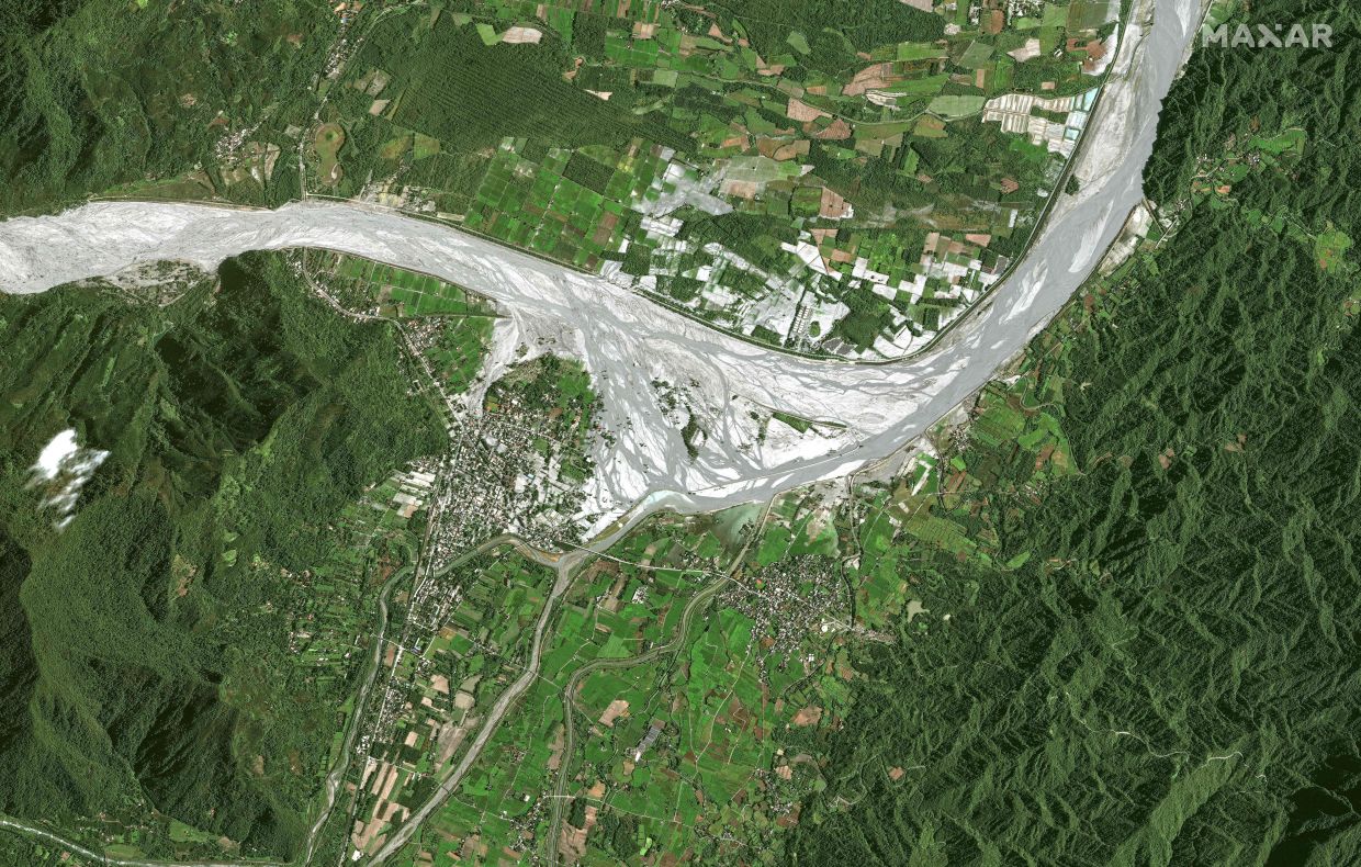 This handout satellite image courtesy of 2025 Maxar Technologies taken on Sept 25, 2025 shows an aerial view of Guangfu town in Hualien, after the barrier lake burst. - AFP