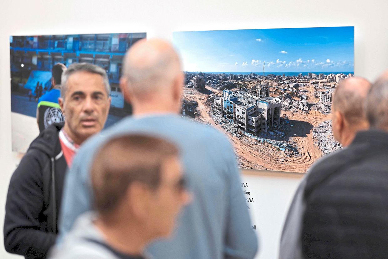 People visit a photography exhibition entitled 'Gaza Through Their Eyes' at the Thyssen-Bornemisza museum in Madrid. Photo: AFP 