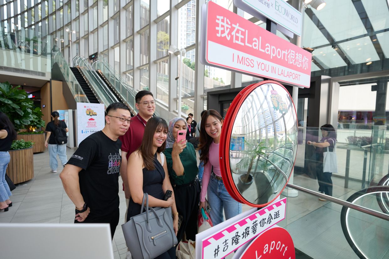 Visitors at a themed photo spot, part of the social media-worthy installations for the Red Dot Event at BBCC.