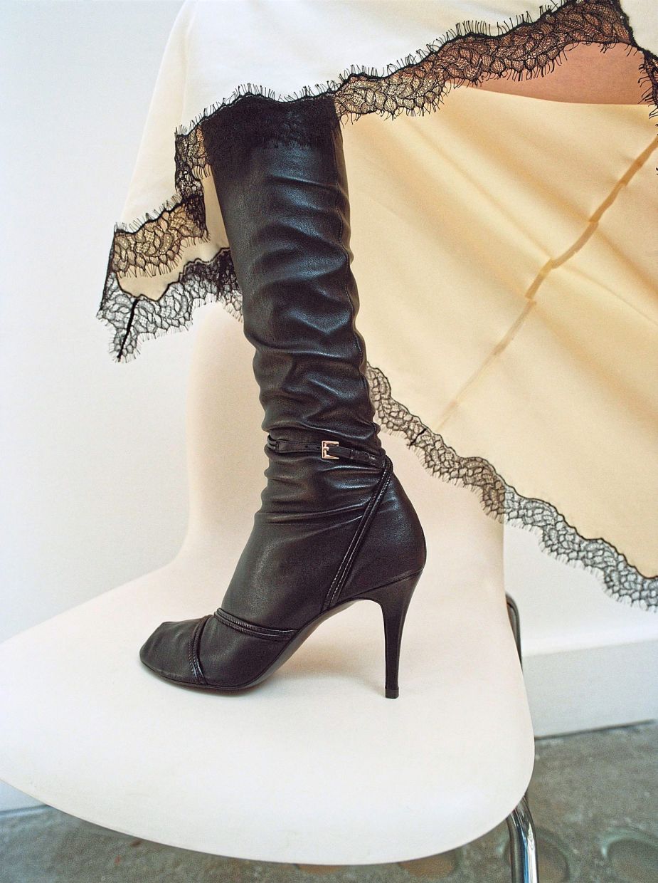 Decorative straps with a buckle and stiletto heels give these high leather boots a sophisticated vibe. Photo: Mango