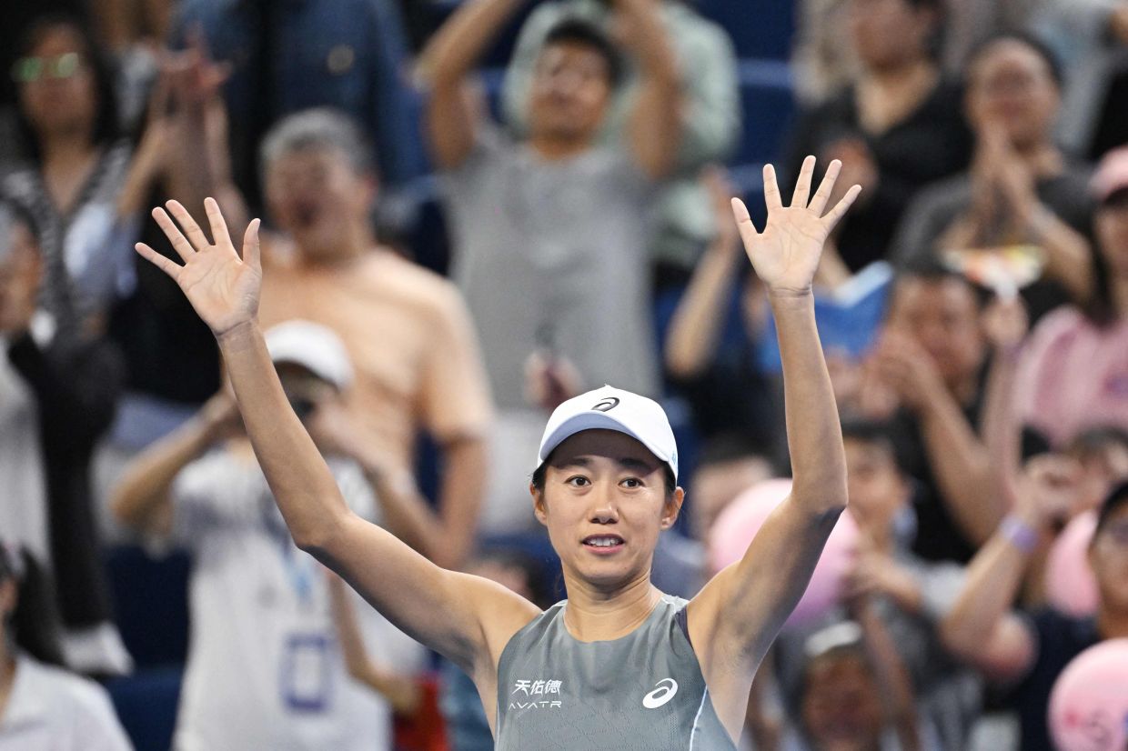 China's Zhang Shuai waves to the crowd after winning her women's singles match against compatriot Wang Xinyu at the China Open tennis tournament in Beijing on Friday, September 26, 2025. -- Photo by GREG BAKER / AFP