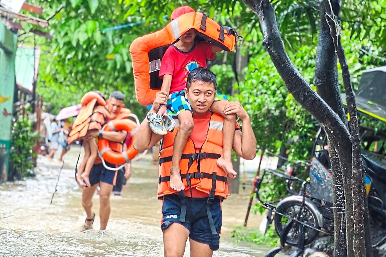 Children being carried to safety. — AFP/AP