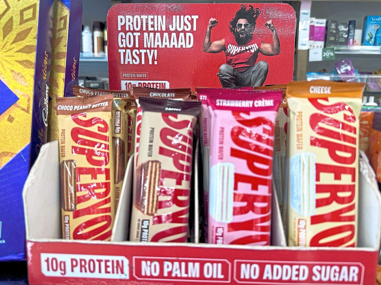 SuperYou co-founder Singh’s advertisement on display behind SuperYou protein wafer bars at a medical store in Mumbai. — Reuters