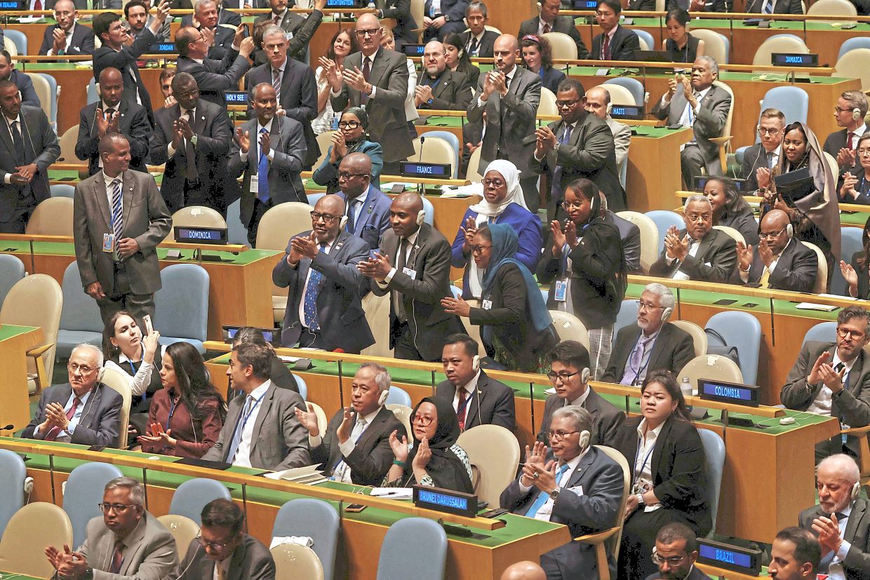 Delegates cheering French President Emmanuel Macron at the UN General Assembly for formally recognising the Palestinian State last week.— AFP
