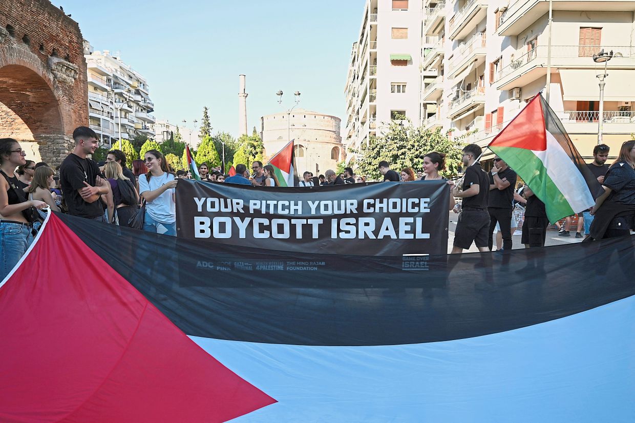 Pro-Palestinian protesters gathering ahead of a Europa League football match between Greece's PAOK football club and Israel's Maccabi Tel Aviv. Banning Israel from international sports tournaments like the World Cup or the Olympics would carry more weight. — AP