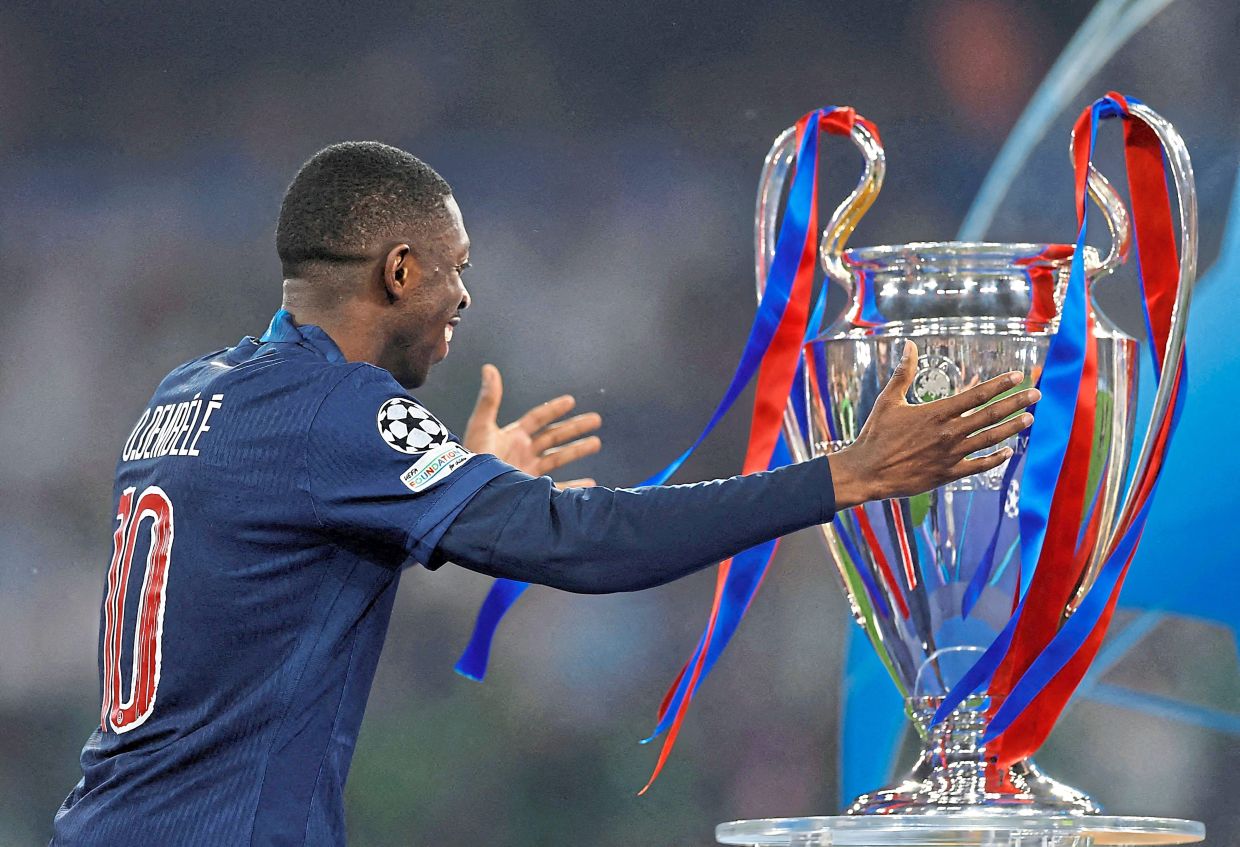 Dembele with the Champions League trophy after collecting his winners medal. — Reuters