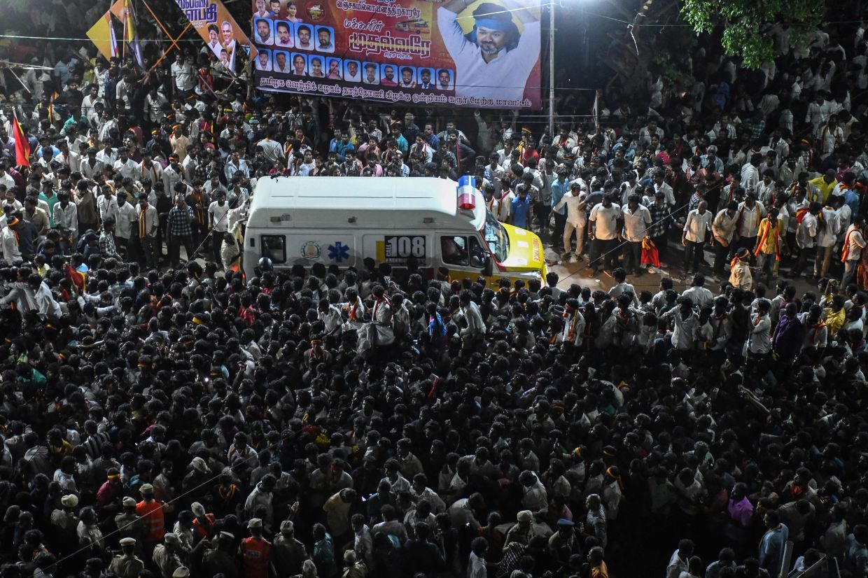 An ambulance carrying victims makes its way through the crowd following a stampede that broke out during a political rally in the Karur district, in the Indian state of Tamil Nadu, on September 27, 2025. A stampede that killed dozens at a south Indian political rally happened after a crowd of thousands waited hours in baking heat without sufficient safeguards, officials and witnesses said on September 28. Some 27,000 people thronged a public road in Tamil Nadu state in hopes of seeing popular actor-turned-politician Vijay on September 27, but panic broke out and 39 were killed, authorities said. -- Photo by AFP