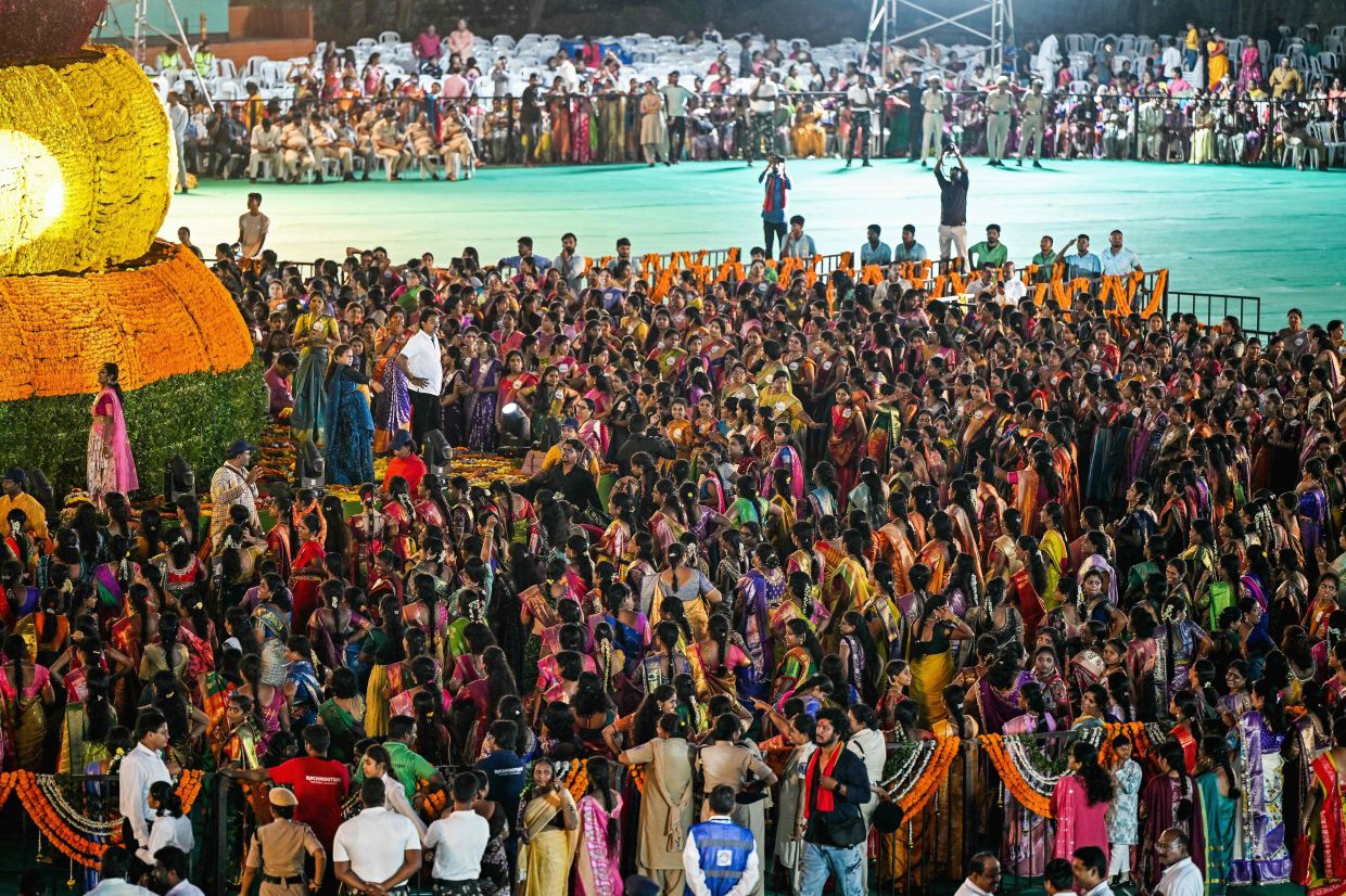 Women surround a floral display as they perform religious rituals to celebrate the Hindu festival of Bathukamma (festival of life) in Hyderabad on Monday, September 29, 2025. -- Photo by Noah SEELAM / AFP