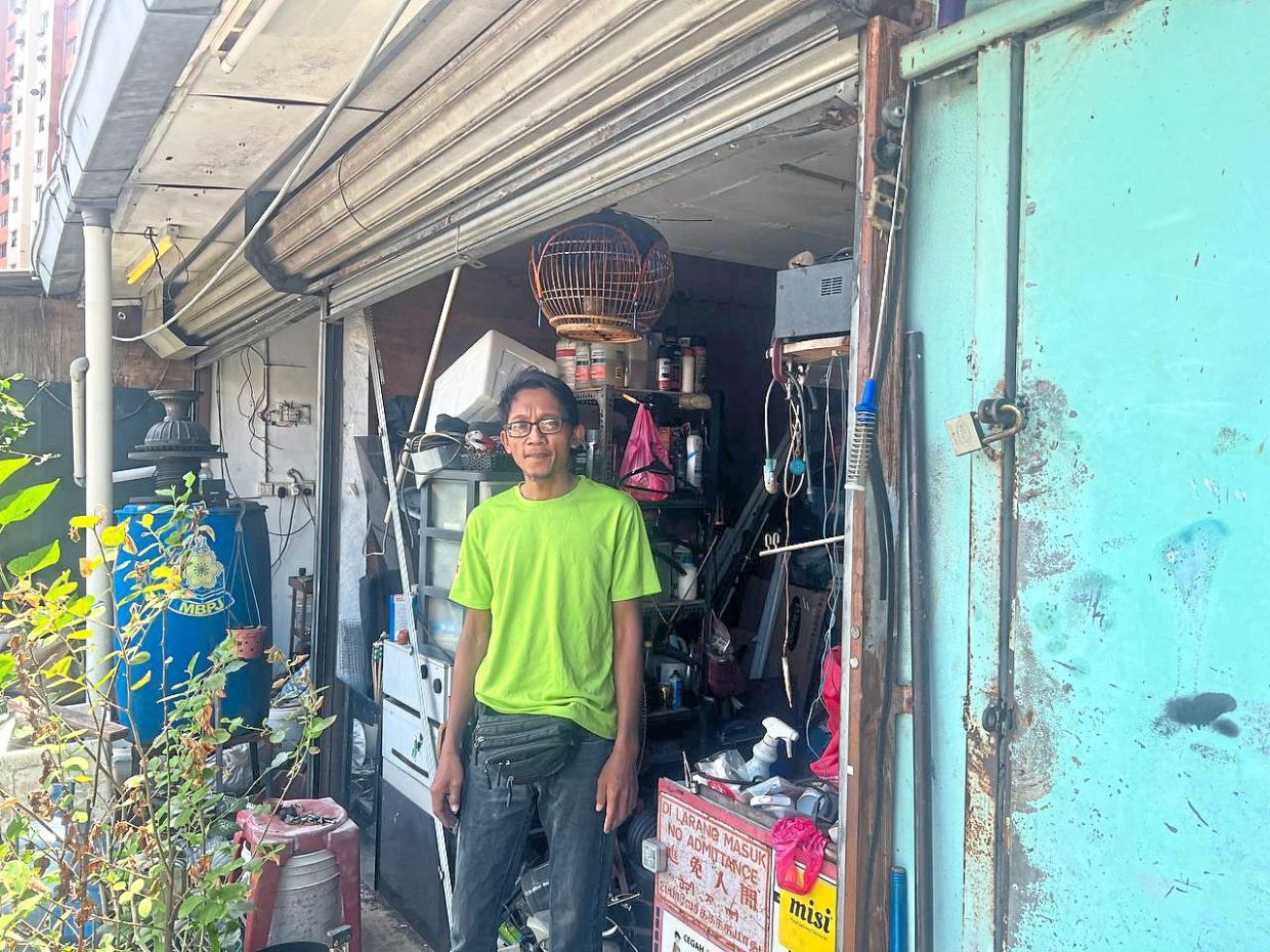 Mohd Noor standing outside his shop at PPR Lembah Subang 1, which is likely to be demolished under the second phase of the MBPJ enforcement.