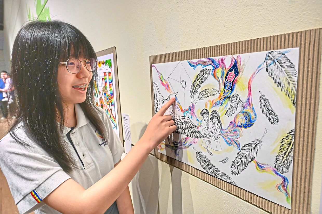 Yan Ying proudly sharing her art piece themed around dialogue and understanding.