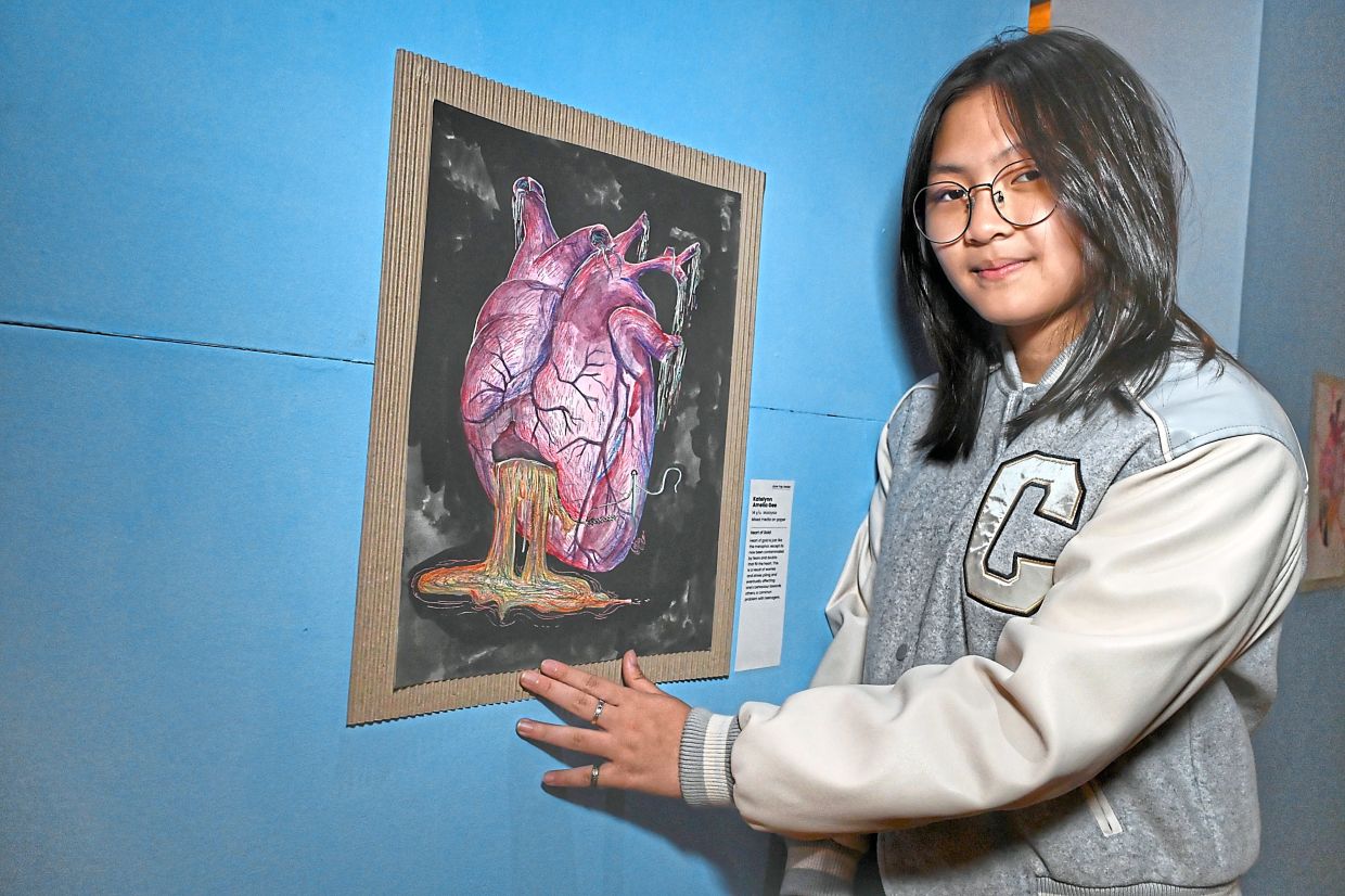 Katelyn Amelia with her artwork that reflects the idea that ‘peace starts from within’.