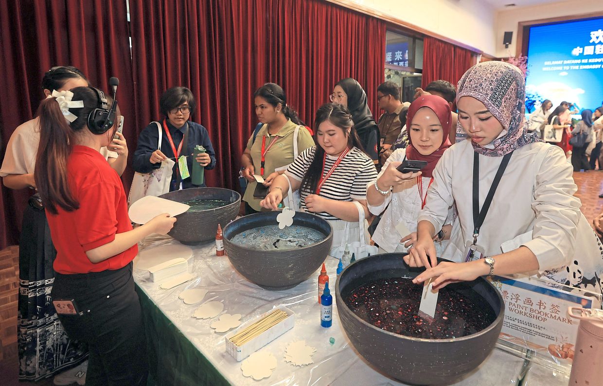 Participants making bookmarks using the float-paint technique.