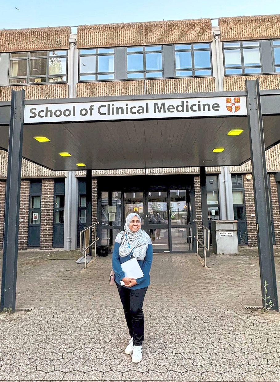 Prestigious place: Hanis posing in front of her faculty in Cambridge.