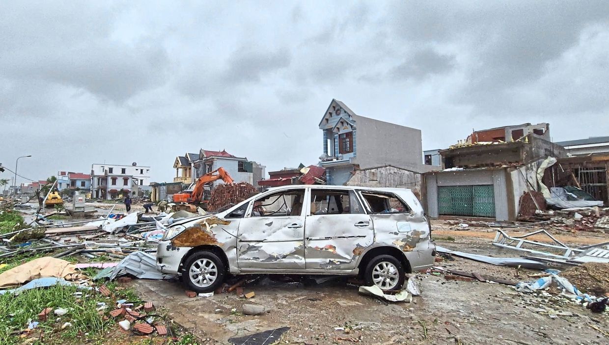 A damaged car is seen amid debris and other damaged buildings after Typhoon Bualoi swept through Thanh Hoa. — AFP/Reuters/AP