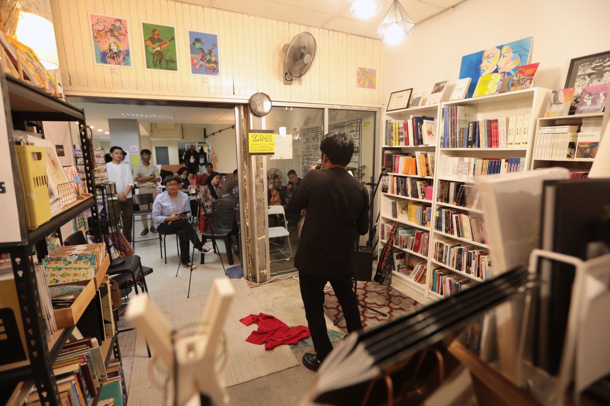 Ipoh poet Karmaa.iw grabs the crowd's attention at an event at Tokosue in Kuala Lumpur. Photo: The Star/Yap Chee Hong