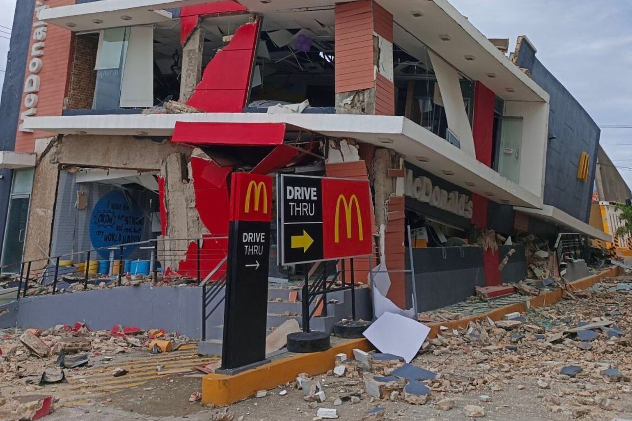 A damaged McDonald's store is seen in Bogo City on Oct 1. - AP