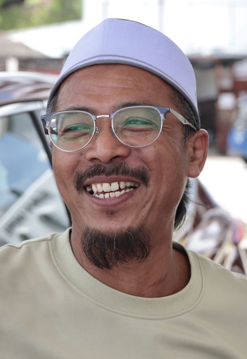 Businessman Izlan Ishak, 47, was happy to be saving money on his petrol expenses with the new scheme, when met at a petrol station along Weld Quay, in George Town, Penang. — ZHAFARAN NASIB/The Star.