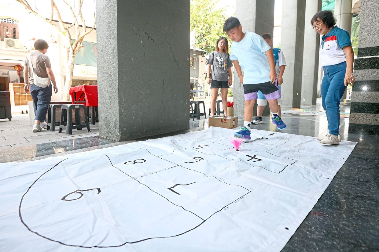 Visitors participating in traditional games along the cultural street.
