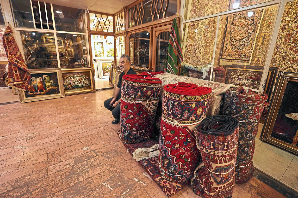 A man selling carpets in Iran's historic market of Tabriz, believed to be one of the oldest bazaars in West Asia.