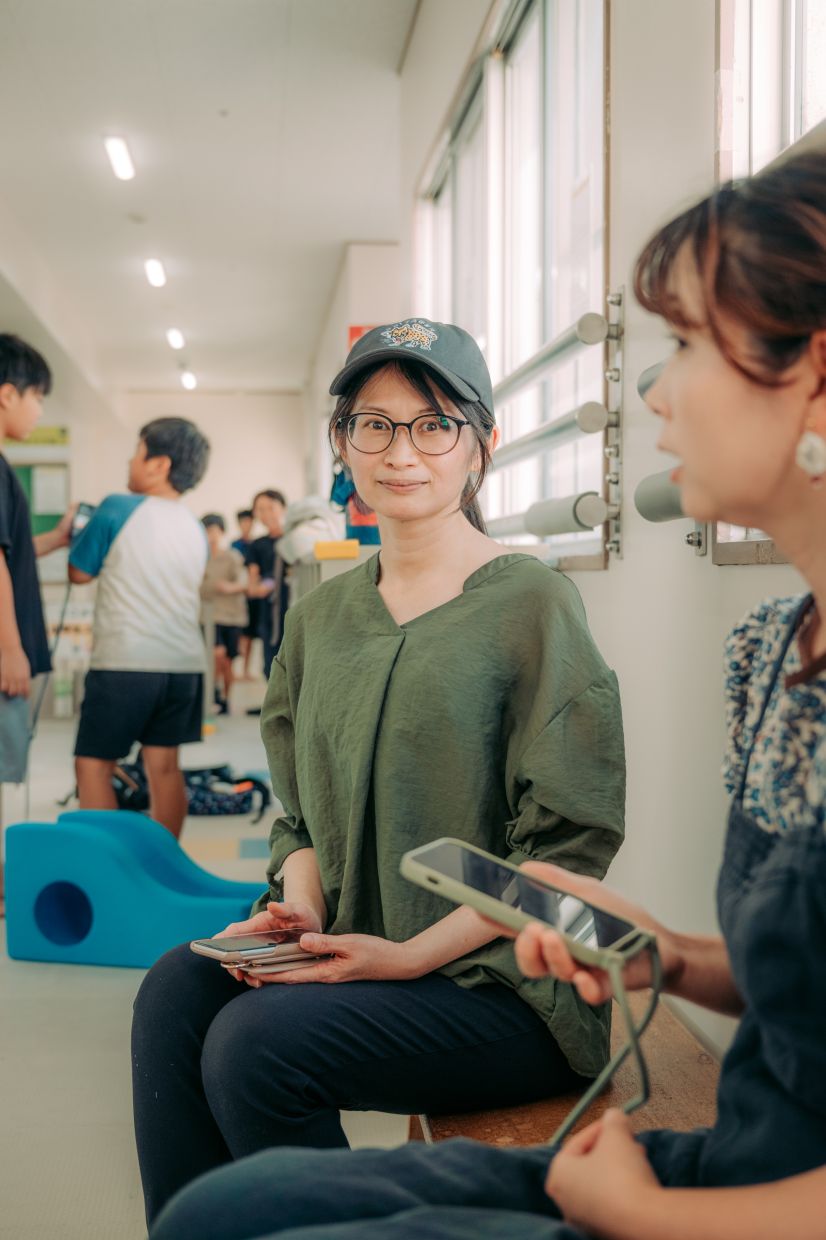 Asami Sahara, a mother and part-time caretaker, with her phone in Toyoake, Japan.