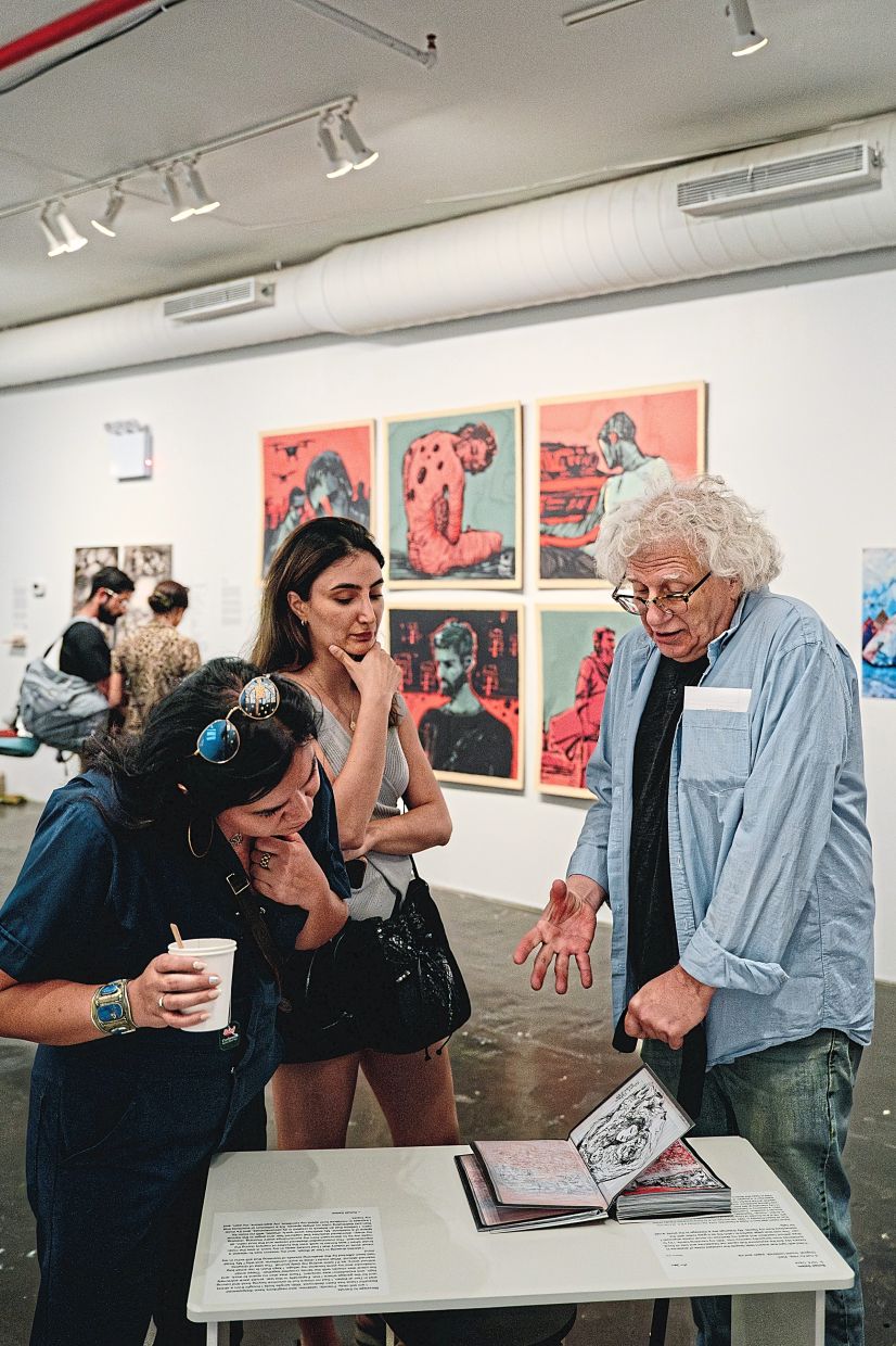 Visitors view and discuss the Palestinian artist Sohail Salem’s war diary on display at Recess Art during the Gaza Biennale in New York last month. Photo: The New York Times/Shuran Huang
