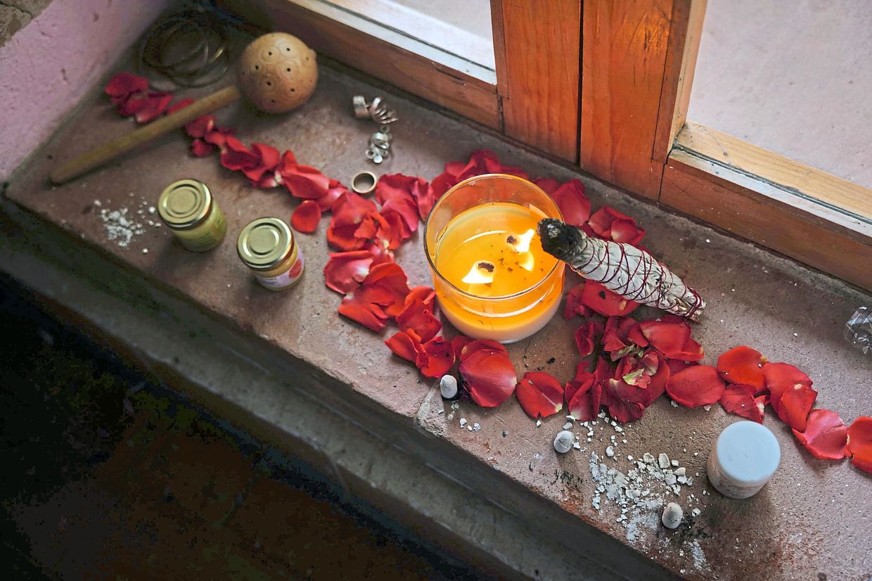 Items including a burning stick of dried mugwort and charcoal are used to warm certain points on the body. Photo: Greta Rico/The New York Times