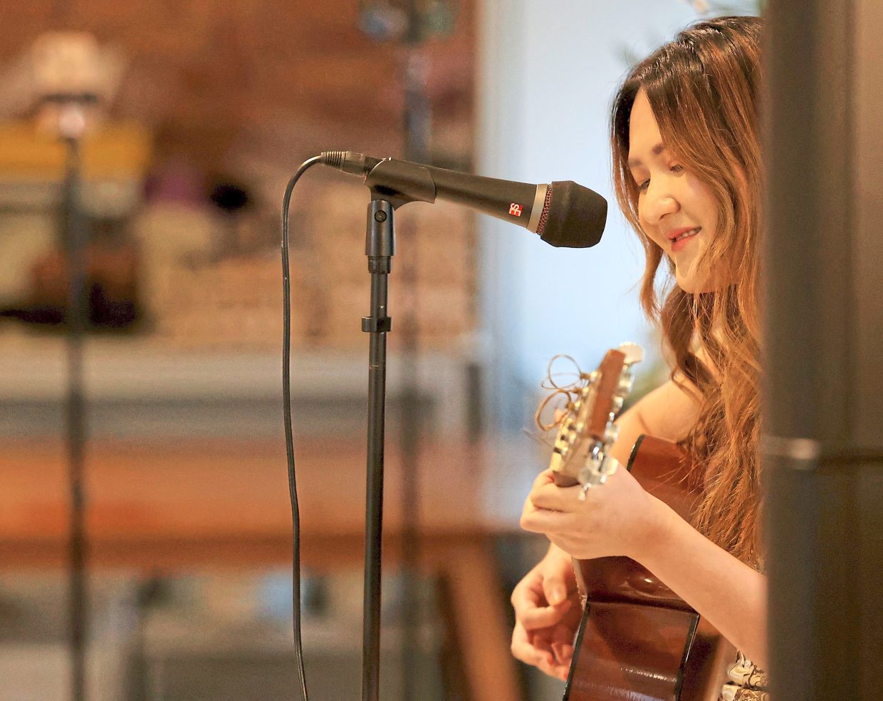 Yeoh, a speech therapist by day and songwriter by night, performs at the recent 'Sacred Grounds' poetry showcase. Photo: The Star/Chan Tak Kong