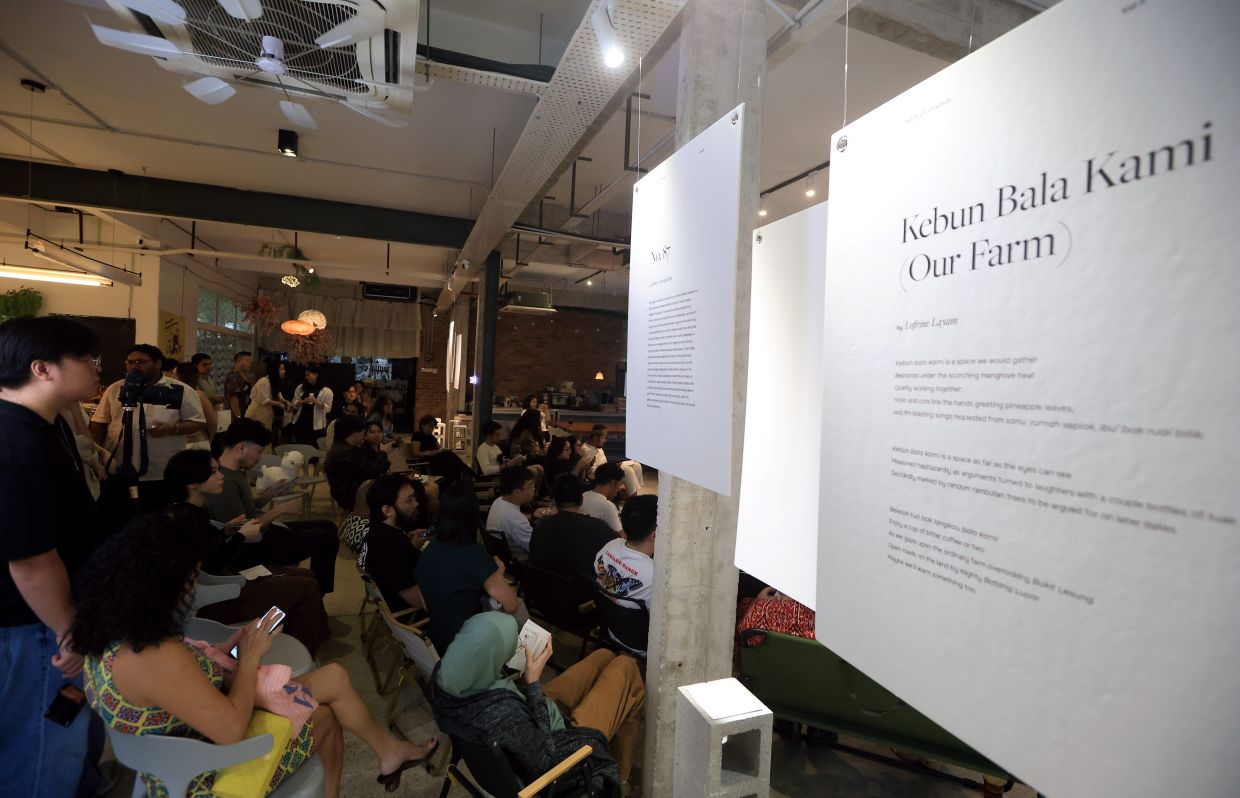 The crowd was drawn to the event by the offering of both poetry and coffee, and listened with quiet attentiveness. Photo: The Star/Chan Tak Kong