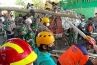 Death toll rises to 14 in Indonesian Islamic school collapse, 49 students still listed as missing